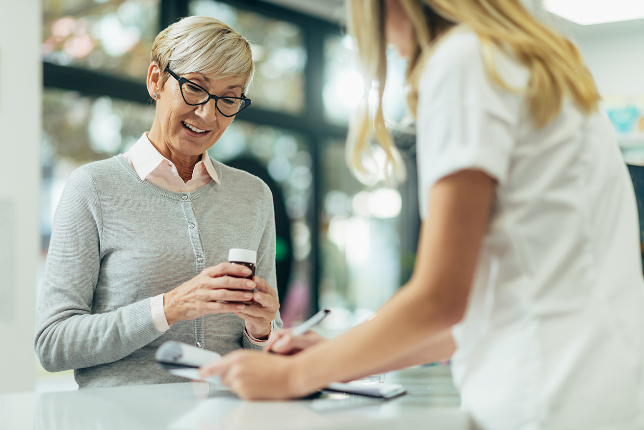 A Sunshine Drugs pharmacist helping a customer