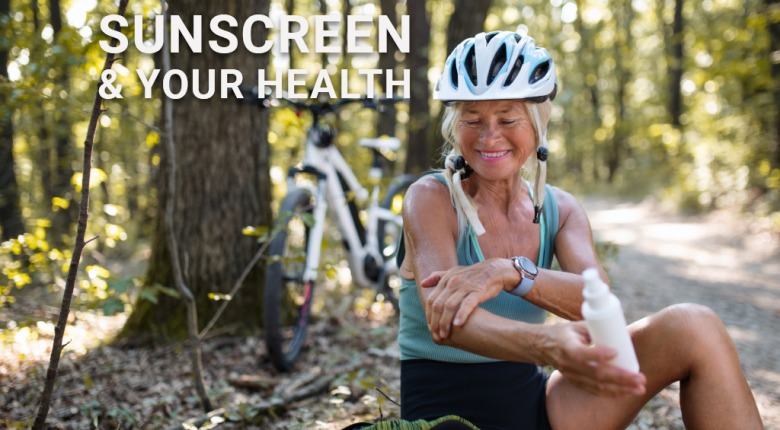 Bike rider applying sunscreen to her arms for sun protection
