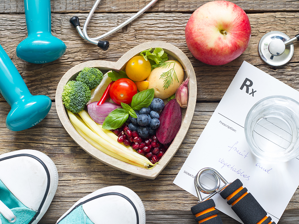 Heart Health Month promoting healthy habits like eating fruits and vegetables, exercising, and managing medications for better heart health.